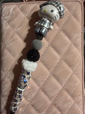 Black and silver Rhinestone pen with Hello Kitty topper and extra pen refill.